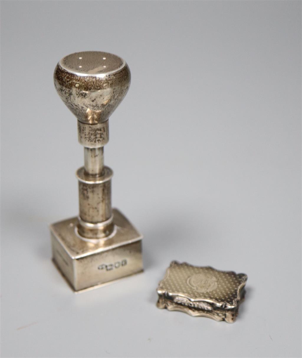 An Edwardian silver stamp press?, William Hornby, London 1902, retailed by Asprey, London, 8cm and a Victorian solver vinaigrette.